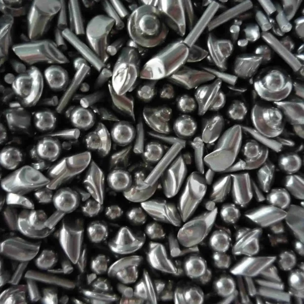 Close-up of stainless steel tumbling shot: angles, balls, cones and pins